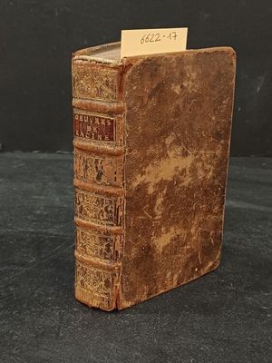 an old book with a note sticking out of it sitting on a table