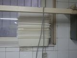 a stack of white plates on a shelf in a kitchen