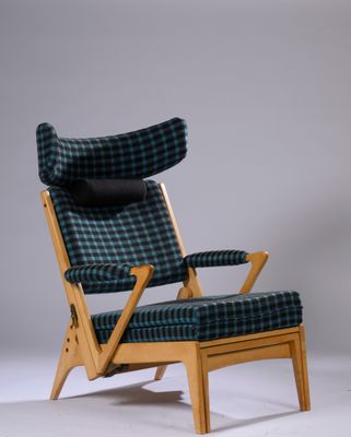 an image of a chair and ottoman in a room with a gray background
