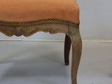 a chair that has been upholstered with an orange upholstered seat
