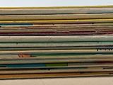 newspapers stacked on top of each other on a table