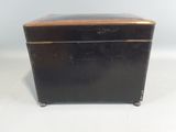 an old black metal box with a wooden top on a white surface