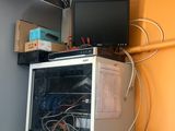 a computer and a monitor on a shelf in a room