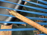 a blue chair with a baseball bat on top of it