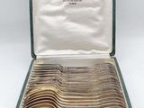 many spoons in a case that are sitting on a table