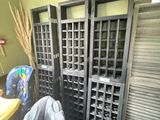 several chairs and a table in a room with a bunch of shutters