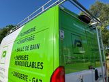 a green van that is parked on the side of the road
