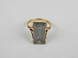 an image of a gold ring with a grey stone in it