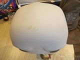 a white helmet on a stand on a table