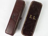 two cases that are sitting on a white surface