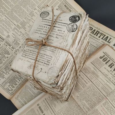 a stack of old newspapers wrapped in twine and tied with twine