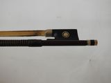 a violin bow and a bow rest on a table