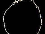 a silver bracelet with a bar on a chain
