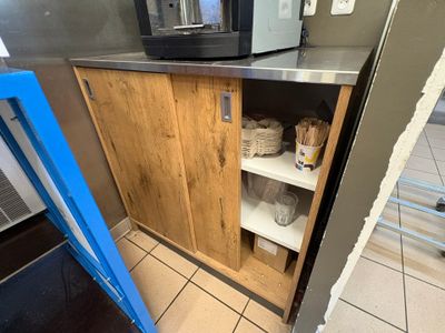 a microwave that is on a shelf in a kitchen