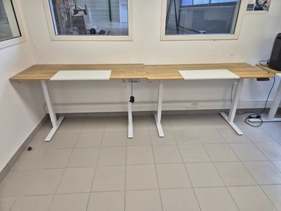 a white desk with a wooden top in a room