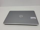 the laptop is sitting on a white table with a sticker on it
