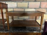 a wooden table with a shelf on top of it