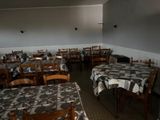 many tables and chairs in a restaurant with black and white checkered tablecloths