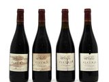 three bottles of wine are lined up on a white surface