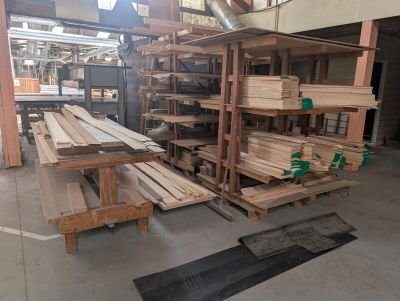 a large amount of wood in a warehouse with pallets on the floor