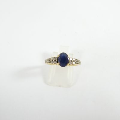 a close up of a ring with a blue stone on it