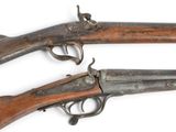 three old guns are displayed on a white surface