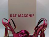the pink shoes are next to a box with a pink bow on it