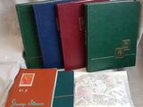 several different colored books are lined up on a white surface