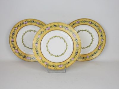 four yellow and white plates with floral designs on them
