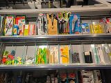 many different types of office supplies on the shelves