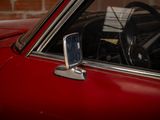 a close up of a red car with a steering wheel