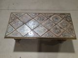 a coffee table that has a tile top on it