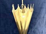 a gold umbrella that is sitting on a blue background