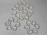 several pieces of silver metal are arranged on a white surface