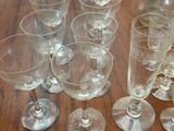 several empty wine glasses and a decanter on a wooden table