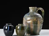 three vases sitting next to each other on a table