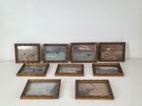 many framed pictures of boats on the water