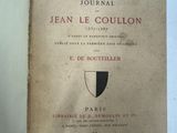 un livre ouvert sur lequel figure un blason