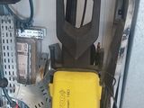 a yellow and black pressurer sitting on the floor in a garage