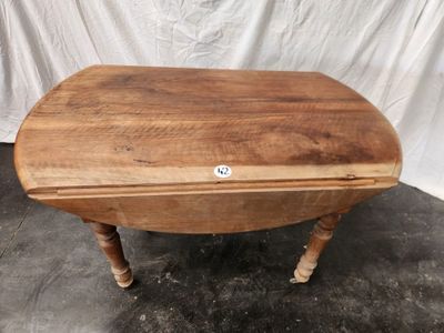 an image of a small wooden table with a white sticker on it