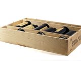 bottles of wine in a wooden box on a white surface