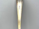 a close up of a spoon on a table with a white background
