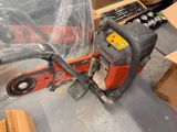 a chainsaw that is sitting on the floor in the room