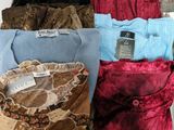 several different colored shirts are lined up on a table