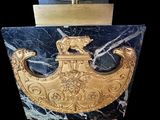 a picture of a gold and black clock with a bell on it