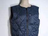 the vest is blue and has a zipper on the front