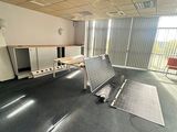 an empty room with a laptop computer on the floor