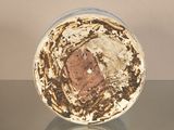 an image of a glass bowl with dirt on it