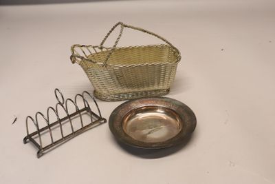 a small metal basket and a metal plate on a table