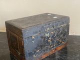 a wooden box sitting on a table with a mirror in the background
